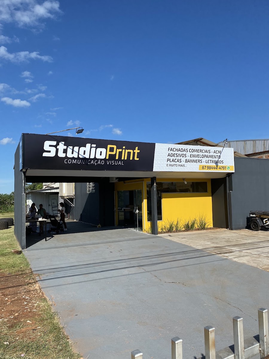 Fachada da Studio Print em Naviraí, com painel preto e branco e frente amarela